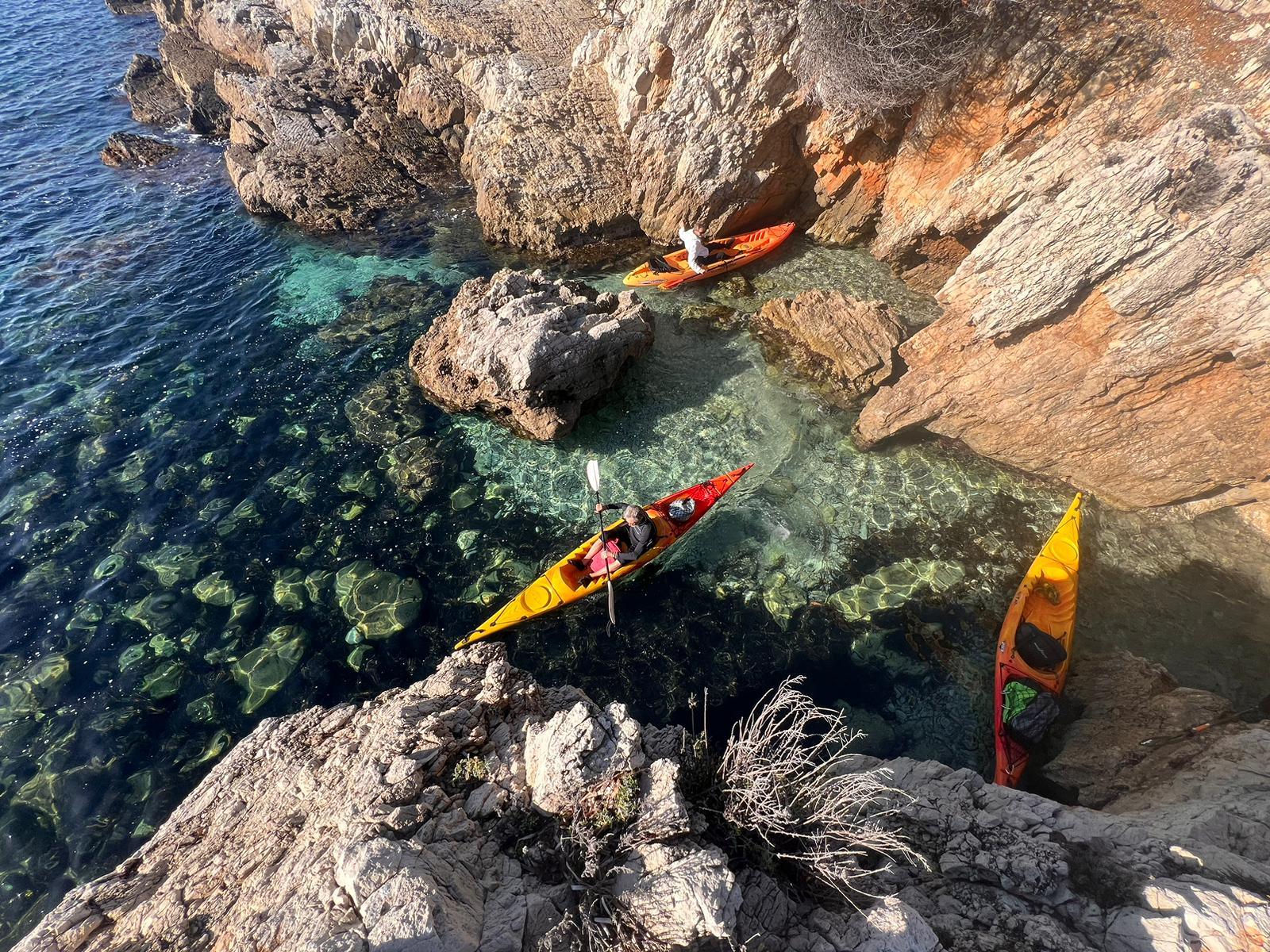 trois kayaks de mer dans une petite crique